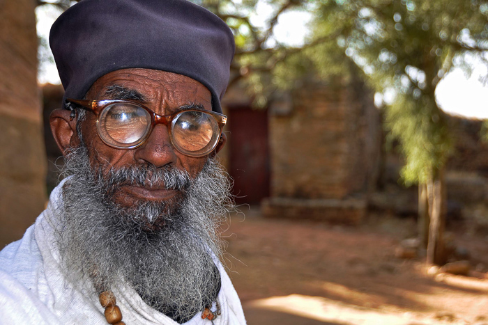 Portait of an older man wearing strong spectacles