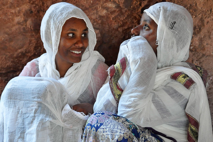 Portrait of two young women seated on the ground